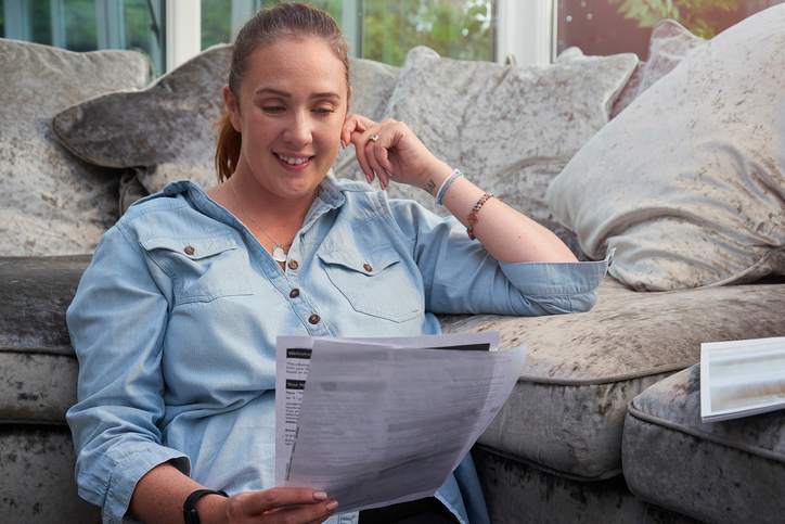 Woman reviews financial refinance documents